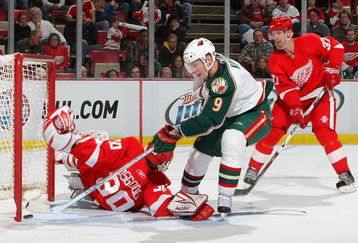 DETROIT - FEBRUARY 12:  Chris Osgood #30 of the Detroit Red Wings is beat by Mikko Koivu #9 of the Minnesota Wild as Mikael Samuelsson #37 of the Detroit Red Wings looks on during their NHL game at Joe Louis Arena February 12, 2009 in Detroit, Michigan.(Photo By Dave Sandford/Getty Images)