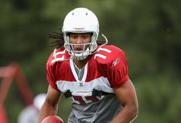 FLAGSTAFF, AZ - JULY 31:  Wide receiver Larry Fitzgerald #11 of the Arizona Cardinals runs with the ball after a reception in the team training camp at Northern Arizona University on July 31, 2009 in Flagstaff, Arizona.  (Photo by Christian Petersen/Getty Images)