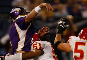 MINNEAPOLIS, MN - AUGUST 21: Quarterback Brett Favre #4 of the Minnesota Vikings gets tackled just after passing the football by linebacker Corey Mays #51 the Kansas City Chiefs at Hubert H. Humphrey Metrodome on August 21, 2009 in Minneapolis, Minnesota. (Photo by Scott Boehm/Getty Images)