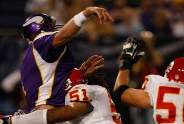 MINNEAPOLIS, MN - AUGUST 21: Quarterback Brett Favre #4 of the Minnesota Vikings gets tackled just after passing the football by linebacker Corey Mays #51 the Kansas City Chiefs at Hubert H. Humphrey Metrodome on August 21, 2009 in Minneapolis, Minnesota. (Photo by Scott Boehm/Getty Images)