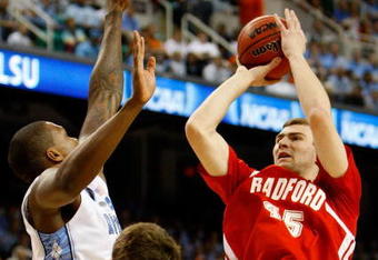 GREENSBORO, NC - MARCH 19:  Artsiom Parakhouski #45 of the Radford Highlanders shoots against Tyler Hansbrough #50 and Deon Thompson #21 the North Carolina Tar Heels during the first round of the NCAA Division I Men's Basketball Tournament at the Greensboro Coliseum on March 19, 2009 in Greensboro, North Carolina.  (Photo by Streeter Lecka/Getty Images)