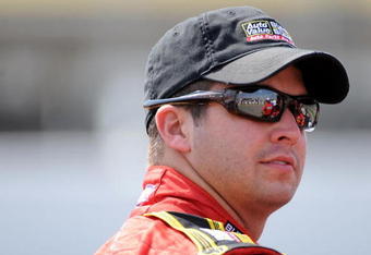 BROOKLYN, MI - AUGUST 14:  Reed Sorenson, driver of the #43 Auto Valve Bumber to Bumber Dodge, waits on pit row during qualifying for the NASCAR Sprint Cup Series Michigan 400 at Michigan Internetional Speedway on August 14, 2009 in Brooklyn, Michigan.  (Photo by Harry How/Getty Images)