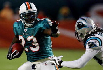 MIAMI - AUGUST 22:  Running back Ronnie Brown #23 of the Miami Dolphins tries to avoid a tackle attempt by Charles Godfrey #30 of the Carolina Panthers during a pre-season game at Land Shark Stadium on August 22, 2009 in Miami, Florida.  (Photo by Doug Benc/Getty Images)
