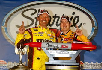 BRISTOL, TN - AUGUST 22: Kyle Busch (R), driver of the #18 M&M's Toyota, poses with crew chief Steve Addington in victory lane after winning the NASCAR Sprint Cup Series Sharpie 500 at Bristol Motor Speedway on August 22, 2009 in Bristol, Tennessee.  (Photo by Jason Smith/Getty Images for NASCAR)