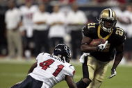 HOUSTON - AUGUST 22: Running back Mike Bell #21 of the New Orleans Saints runs past cornerback Brice McCain #41 of the Houston Texans on August 22, 2009 in Houston, Texas. (Photo by Bob Levey/Getty Images)