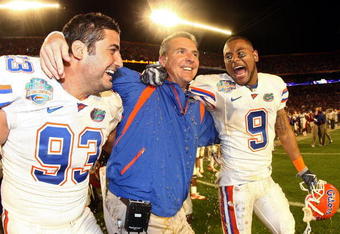 MIAMI - JANUARY 08:  Head coach Urban Meyer of the Florida Gators gets gatorade dumped on him as Javier Estopinan #93 and Louis Murphy #9 look on towards the end of the game against the Oklahoma Sooners in the FedEx BCS National Championship Game at Dolphin Stadium on January 8, 2009 in Miami, Florida.  The Gators wons the game by a score of 24-14.  (Photo by Donald Miralle/Getty Images)