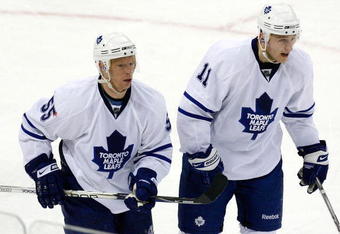 RALEIGH, NC - JANUARY 15:  Jason Blake #55 of the Toronto Maple Leafs skates off with Jiri Tlusty #11 after Blake scored a hat trick with an empty netter in the final seconds of their 6-4 win over the Carolina Hurricanes during the game on January 15, 2009 at RBC Center in Raleigh, North Carolina.  (Photo by Kevin C. Cox/Getty Images)