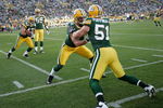 GREEN BAY, WI - AUGUST 22: Linebackers Aaron Kampman #74 and Brady Poppinga #51 of the Green Bay Packers run blocking drills as Stryker Sulak #47 runs with the football and Brad Jones #59 looks on during warm ups prior to the game against the Buffalo Bills at Lambeau Field on August 22, 2009 in Green Bay. Wisconsin.  (Photo by Scott Boehm/Getty Images)