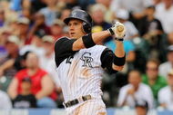 DENVER - AUGUST 13: Clint Barmes #12 of the Colorado Rockies looks on as he hits a two-run home run in the seventh inning at Coors Field on August 13, 2009 in Denver, Colorado. (Photo by Doug Pensinger/Getty Images)