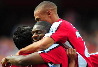 LONDON, ENGLAND - AUGUST 22:  Abou Diaby of Arsenal celebrates his goal with teammate Eduardo (L) and Kieran Gibbs during the Barclays Premier League match between Arsenal and Portsmouth at the Emirates Stadium on August 22, 2009 in London, England.  (Photo by Mike Hewitt/Getty Images)