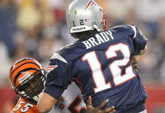 FOXBORO, MA - AUGUST 20:  Tom Brady #12 of the New England Patriots feels the pressure of Keith Rivers #55 of the Cincinnati Bengals at Gillette Stadium on August 20, 2009 in Foxboro, Massachusetts. (Photo by Jim Rogash/Getty Images)