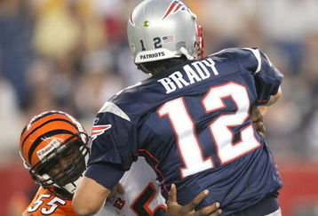 FOXBORO, MA - AUGUST 20:  Tom Brady #12 of the New England Patriots feels the pressure of Keith Rivers #55 of the Cincinnati Bengals at Gillette Stadium on August 20, 2009 in Foxboro, Massachusetts. (Photo by Jim Rogash/Getty Images)