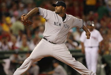 BOSTON - AUGUST 23:  CC Sabathia #52 of the New York Yankees delivers a pitch in the first inning against the Boston Red Sox on August 23, 2009 at Fenway Park in Boston, Massachusetts.  (Photo by Elsa/Getty Images)