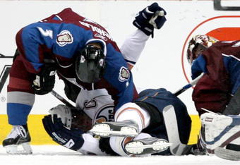 DENVER - MARCH 19:  Ethan Moreau #18 of the Edmonton Oilers gets pinned by Lawrence Nycholat #3 of the Colorado Avalanche during NHL action at the Pepsi Center on March 19, 2009 in Denver, Colorado. The Oilers defeated the Avalanche 8-1.  (Photo by Doug Pensinger/Getty Images)