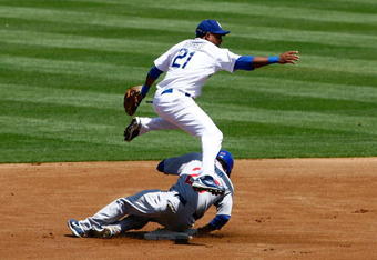 LOS ANGELES, CA - AUGUST 23:  Second baseman Tony Abreu #21 of the Los Angeles Dodgers throws to first base, avoiding the sliding Sam Fuld #27 of the Chicago Cubs to complete the double play in the first inning at Dodger Stadium on August 23, 2009 in Los Angeles, California. The Cubs defeated the Dodgers 3-1.  (Photo by Jeff Gross/Getty Images)