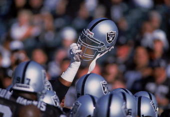 4 Aug 2001:  A player of the Oakland Raiders holds up his helmet during the Pre-Season game against the Dallas Cowboys at the network Associates Coliseum in Oakland, California. The Raiders defeated the Cowboys 21-14.Mandatory Credit: Jed Jacobsohn  /Allsport