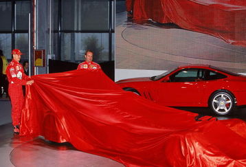 6th Feb 2002:  Michael Schumacher (L) of Germany and Rubens Barrichello of Brazil and Ferrari remove the covers of the new Ferrari car during the press conference held to launch the new Ferrari F2002 Formula One car in Maranello, Italy.  \ Mandatory Credit: Mark Thompson /Allsport