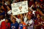 MIAMI - JANUARY 08:  A fan holds up a sign in reference to an ongoing rumor that the Notre Dame Fighting Irish have been interested in hiring Urban Meyer, head coach of the Florida Gators, during the FedEx BCS National Championship game against the Oklahoma Sooners at Dolphin Stadium on January 8, 2009 in Miami, Florida.  (Photo by Marc Serota/Getty Images)
