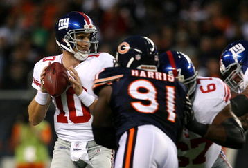 CHICAGO - AUGUST 22: Quarterback Eli Manning #10 of the New York Giantslooks to pass as he is pressured by Tommie Harris #91 of the Chicago Bears during their preseason NFL game at Soldier Field on August 22, 2009 in Chicago, Illinois.  (Photo by Jonathan Daniel/Getty Images)