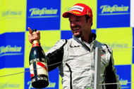 VALENCIA, SPAIN - AUGUST 23:  Rubens Barrichello of Brazil and Brawn GP celebrates on the podium after winning the European Formula One Grand Prix at the Valencia Street Circuit on August 23, 2009, in Valencia, Spain.  (Photo by Clive Mason/Getty Images)