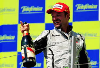 VALENCIA, SPAIN - AUGUST 23:  Rubens Barrichello of Brazil and Brawn GP celebrates on the podium after winning the European Formula One Grand Prix at the Valencia Street Circuit on August 23, 2009, in Valencia, Spain.  (Photo by Clive Mason/Getty Images)