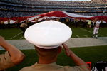 SAN DIEGO - AUGUST 15:  A U.S. Marine salutes a giant American flag during pregame ceremonies for the game between the Seattle Seahawks the San Diego Chargers on August 15, 2009 at Qualcomm Stadium in San Diego, California.   The Seahawks won 20-17.  (Photo by Stephen Dunn/Getty Images)