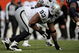 DENVER - NOVEMBER 23:  Defensive tackle Tommy Kelly #93 of the Oakland Raiders defends against the Denver Broncos during week 12 NFL action at Invesco Field at Mile High on November 23, 2008 in Denver, Colorado. The Raiders defeated the Broncos 31-10.  (Photo by Doug Pensinger/Getty Images)