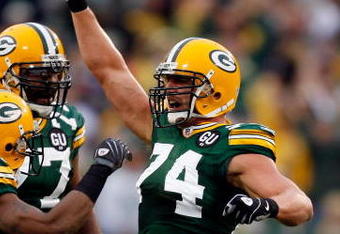 GREEN BAY, WI - SEPTEMBER 08:  (R) Aaron Kampman#74 of the Green Bay Packers reacts with teammates after sacking quarterback Tarvaris Jackson #7 of the Minnesota Vikings in the first quarter on September 8, 2008 at Lambeau Field in Green Bay, Wisconsin.  (Photo by Dilip Vishwanat/Getty Images)