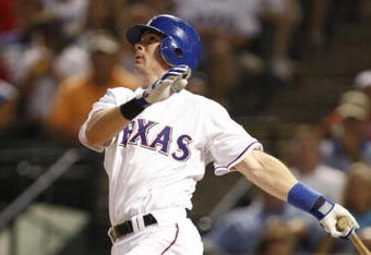 ARLINGTON, TX - JULY 20:  Michael Young #10 of the Texas Rangers watches his solo home run in the sixth inning to tie the Boston Red Sox 2-2 at Rangers Ballpark in Arlington on July 20, 2009 in Arlington, Texas. (Photo by Ronald Martinez/Getty Images)