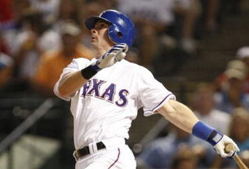 ARLINGTON, TX - JULY 20:  Michael Young #10 of the Texas Rangers watches his solo home run in the sixth inning to tie the Boston Red Sox 2-2 at Rangers Ballpark in Arlington on July 20, 2009 in Arlington, Texas. (Photo by Ronald Martinez/Getty Images)