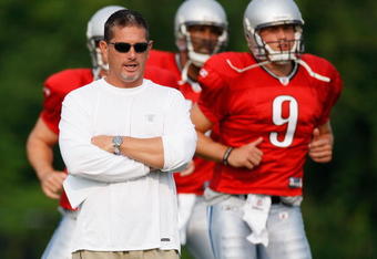ALLEN PARK, MI - AUGUST 04:  Head coach Jim Schwartz looks on while Matthew Stafford #9 and Daunte Culpepper #11 warm up during training camp at the Detroit Lions Headquarters and Training Facility on August 4, 2009 in Allen Park, Michigan.  (Photo by Gregory Shamus/Getty Images)