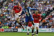 WIGAN, ENGLAND - AUGUST 22:  Wayne Rooney (L) of Manchester United scores the opening goal during the Barclays Premier League match between Wigan Athletic and Manchester United at the DW Stadium on August 22, 2009 in Wigan, England.  (Photo by Alex Livesey/Getty Images)