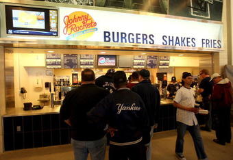 NEW YORK - APRIL 02:  Spectators wait for food at Johnny Rockets during a New York Yankees workout at the new Yankee Stadium on April 2, 2009 in the Bronx borough of New York City.  (Photo by Ezra Shaw/Getty Images)
