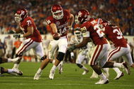 MIAMI - JANUARY 08:  Sam Bradford #14 of the Oklahoma Sooners hands the ball off to Chris Brown #29 against the Florida Gators during the FedEx BCS National Championship game at Dolphin Stadium on January 8, 2009 in Miami, Florida. Florida won 24-14. (Photo by Doug Benc/Getty Images)