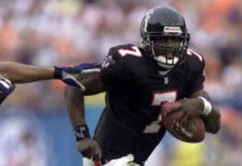 30 Dec 2001: Michael Vick # 7 of the Atlanta Falcons tries to evade the Miami Dolphins defense in the fourth quarter at ProPlayer Stadium in Miami Florida. Dolphins won 21-14. DIGITAL IMAGE. Mandatory Credit: Eliot Schechter/Getty Images