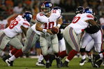 CHICAGO - AUGUST 22: Eli Manning #10 of the New York Giants turns to hand-off during a pre-season game against the Chicago Bears on August 22, 2009 at Soldier Field in Chicago, Illinois. The Bears defeated the Giants 17-3. (Photo by Jonathan Daniel/Getty Images)