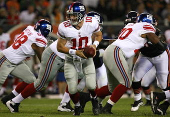 CHICAGO - AUGUST 22: Eli Manning #10 of the New York Giants turns to hand-off during a pre-season game against the Chicago Bears on August 22, 2009 at Soldier Field in Chicago, Illinois. The Bears defeated the Giants 17-3. (Photo by Jonathan Daniel/Getty Images)