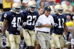 SOUTH BEND, IN - SEPTEMBER 13:  Former head coach Lou Holtz of the Notre Dame Fighting Irish walks out for the coin toss with David Grimes #11, David Bruton #27 and Maurice Crum #40 prior to playing the Michigan Wolverines on September 13, 2008 at Notre Dame Stadium in South Bend, Indiana.  (Photo by Gregory Shamus/Getty Images)