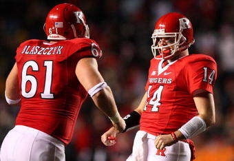 PISCATAWAY, NJ - DECEMBER 04:  Mike Teel #14 of the Rutgers Scarlet Knights (R) celebrates throwing the sixth touchdown pass with teammate Ryan Blaszczyk #61 during the second quarter of the game against the Louisville Cardinals at Rutgers Stadium on December 4, 2008 in Piscataway, New Jersey.  (Photo by Jim McIsaac/Getty Images)