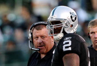 OAKLAND, CA - AUGUST 13:  Head coach Tom Cable talks with his quarterback JaMarcus Russell #2 of the Oakland Raiders in the first quarter against the Dallas Cowboys during the preseason game at Oakland-Alameda County Coliseum on August 13, 2009 in Oakland, California. (Photo by Jed Jacobsohn/Getty Images)