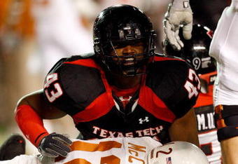 LUBBOCK, TX - NOVEMBER 01:  McKinner Dixon #43 of the Texas Tech Red Raiders tackles sacks quarterback Colt McCoy #12 of the Texas Longhorns during the first half of the game on November 1, 2008 at Jones Stadium in Lubbock, Texas.  (Photo by Jamie Squire/Getty Images)