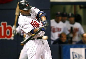 MINNEAPOLIS, MN- SEPTEMBER 28: Delmon Young #21 of the Minnesota Twins singles in the seventh inning scoring Alexi Casilla and Joe Mauer in a game against the Kansas City Royals at the Metrodome on September 28, 2008 in Minneapolis, Minnesota. The Twins defeated the Royals 6-0. (Photo by Scott A. Schneider/Getty Images)