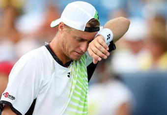 CINCINNATI - AUGUST 21:  Lleyton Hewitt of Australia wipes sweat from his face against Roger Federer of Switzerland during day five of the Western & Southern Financial Group Masters on August 21, 2009 at the Lindner Family Tennis Center in Cincinnati, Ohio.  (Photo by Nick Laham/Getty Images)