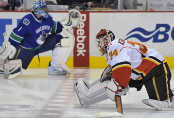VANCOUVER, CANADA - APRIL 7: Miikka Kiprusoff #34 of the Calgary Flames (R) and Roberto Luongo #1 of the Vancouver Canucks (L) stretch prior to the start of their game at General Motors Place April 7, 2009 in Vancouver, Canada.   (Photo by Nick Didlick/Getty Images)
