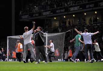 LONDON, ENGLAND - AUGUST 25:  Fans invade the pitch during the Carling Cup second round match between West Ham United and Millwall at Upton Park on August 25, 2009 in London, England.  . Violence broke out between West Ham and Millwall supporters, prior to kick off in tonight's second round Carling Cup at Upton Park. According to reports bricks and bottles were being used as missiles as fans broke through a riot police divide  (Photo by Shaun Botterill/Getty Images)