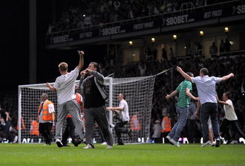 LONDON, ENGLAND - AUGUST 25:  Fans invade the pitch during the Carling Cup second round match between West Ham United and Millwall at Upton Park on August 25, 2009 in London, England.  . Violence broke out between West Ham and Millwall supporters, prior to kick off in tonight's second round Carling Cup at Upton Park. According to reports bricks and bottles were being used as missiles as fans broke through a riot police divide  (Photo by Shaun Botterill/Getty Images)