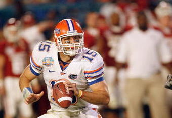 MIAMI - JANUARY 08:  Quarterback Tim Tebow #15 of the Florida Gators runs to pass the ball against the Oklahoma Sooners during the FedEx BCS National Championship Game at Dolphin Stadium on January 8, 2009 in Miami, Florida.  (Photo by Eliot J. Schechter/Getty Images