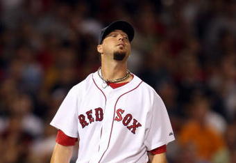 BOSTON - AUGUST 23:  Josh Beckett #19 of the Boston Red Sox reacts after a solo home run by Hideki Matsui #55 of the New York Yankees in the eighth inning on August 23, 2009 at Fenway Park in Boston, Massachusetts.  (Photo by Elsa/Getty Images)