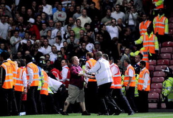 LONDON, ENGLAND - AUGUST 25:  A West Ham United fan confronts the stewards during the Carling Cup second round match between West Ham United and Millwall which was marred by violence at Upton Park on August 25, 2009 in London, England.  (Photo by Shaun Botterill/Getty Images)