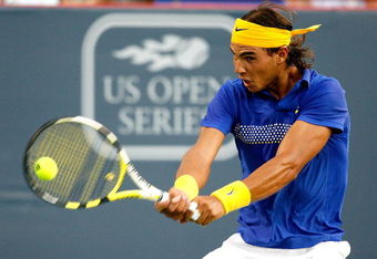 MONTREAL, QC - AUGUST 12:  Rafael Nadal of Spain returns a shot to David Ferrer of Spain during the Rogers Cup at Uniprix Stadium on August 12, 2009 in Montreal, Canada.  (Photo by Matthew Stockman/Getty Images)